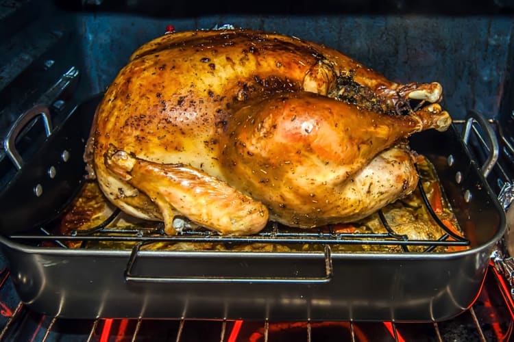 A whole turkey being cooked in an oven