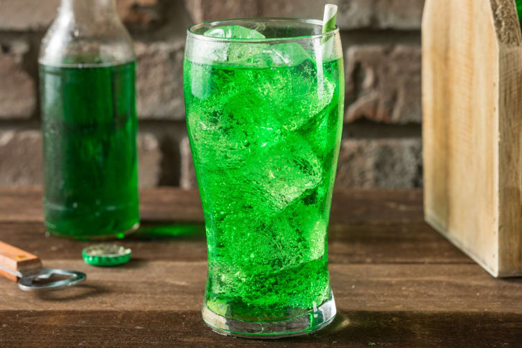 A glass of bright green soda