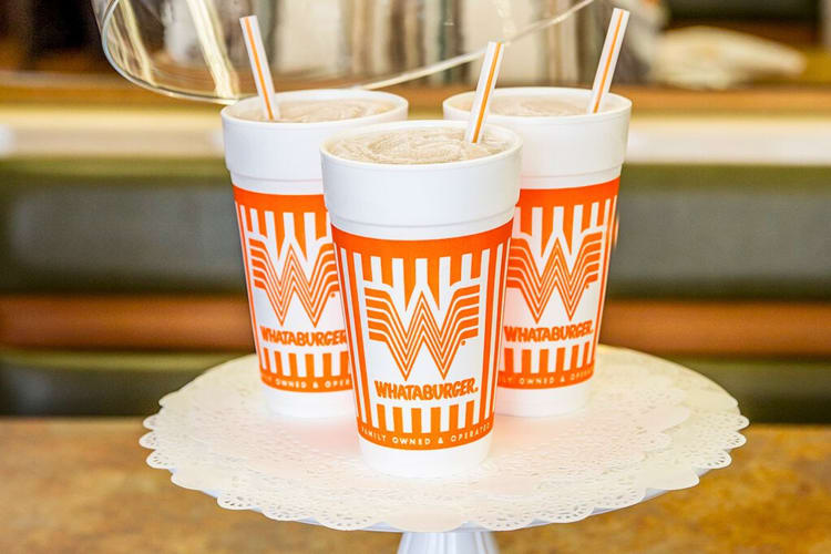 Three drinks in orange Whataburger cups