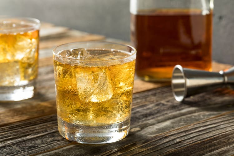 A drink with scotch, soda water and ice