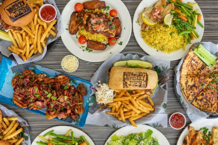 Whiskey Joe's Tampa restaurant table full of plates of delicious food