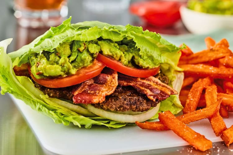 Lettuce wrap loaded with beef patty, bacon, avocado, tomato and onion.