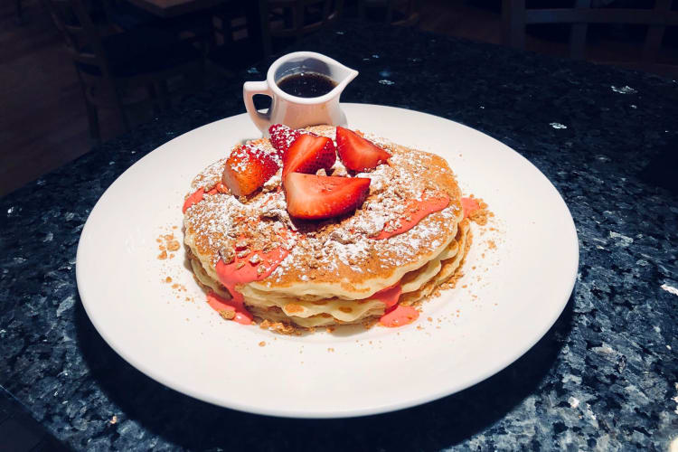 Pancakes with strawberries and syrup from Yolk in Indianapolis