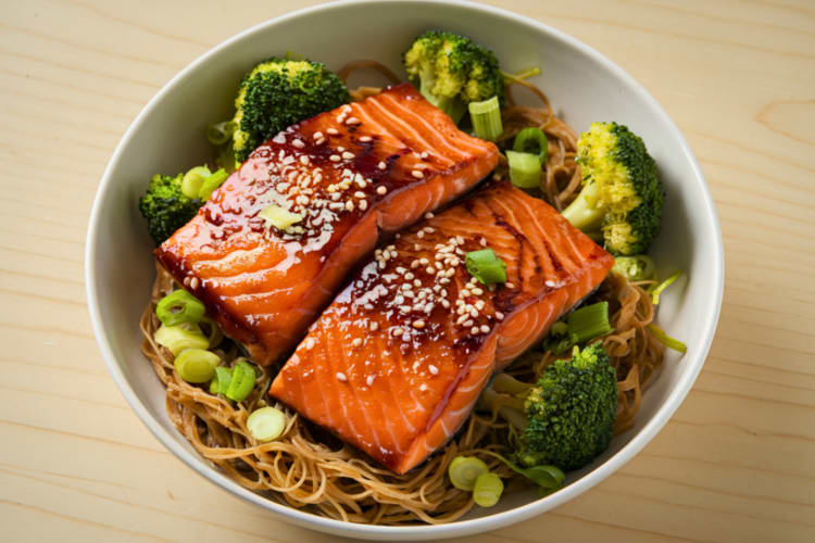 a plate of salmon and noodles
