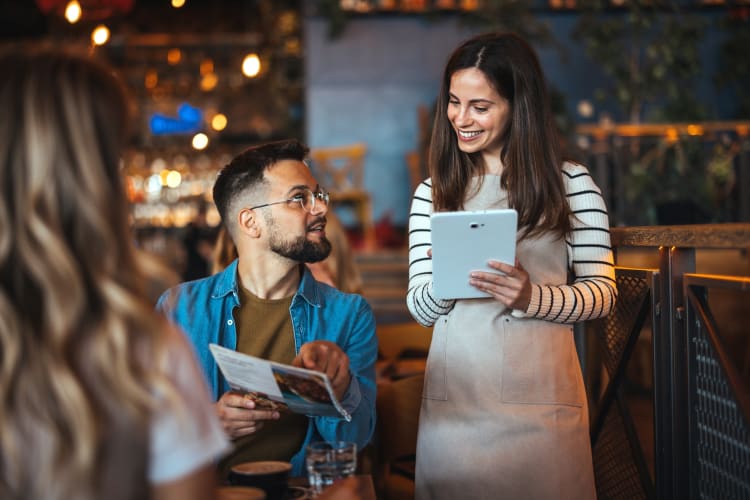 Waiter and customer at restaurant