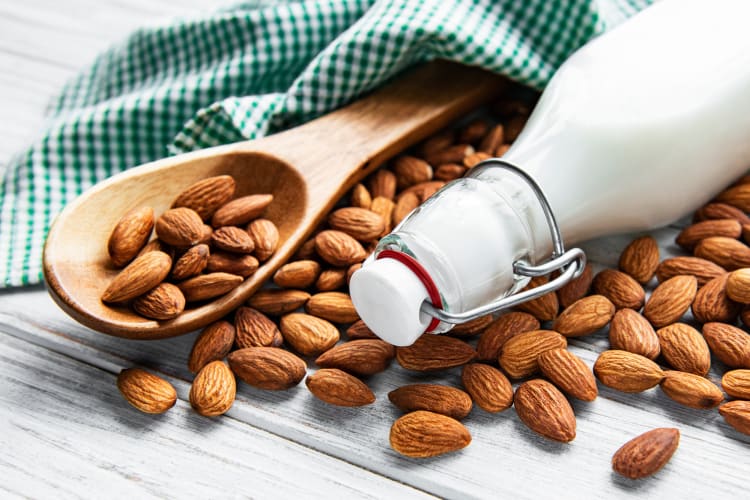 almonds on a table with almond milk