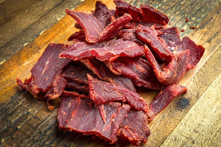Beef jerky, a popular American food, on a wooden surface