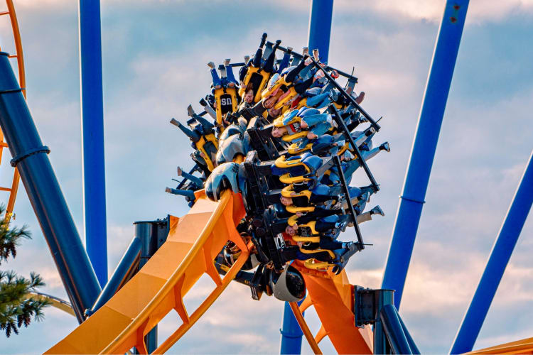 People riding a roller coaster at Six Flags
