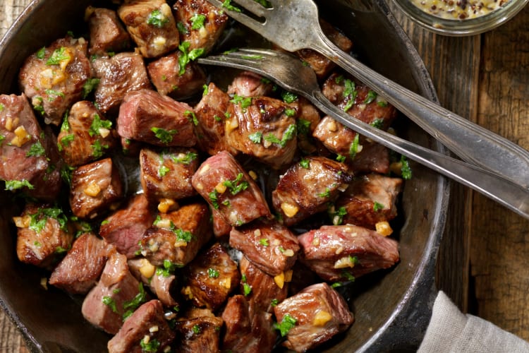 Garlic steak bites served with cilantro