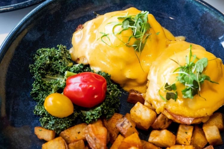 Eggs bendecit served with potatoes and salad