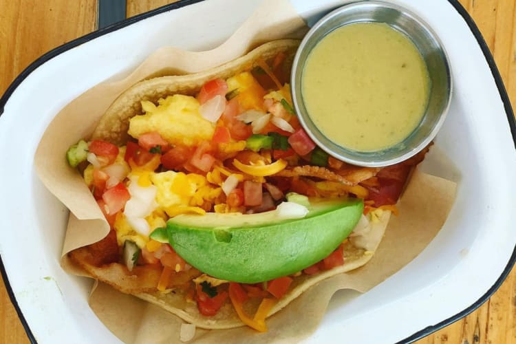 Breakfast tacos served with pico de gallo and avocado