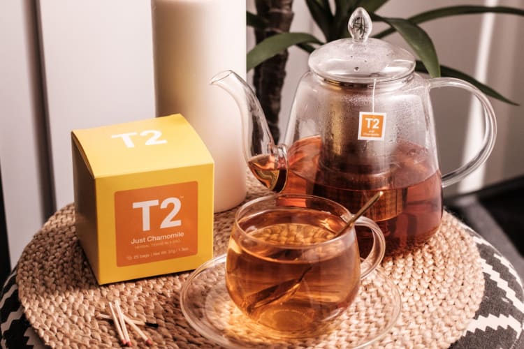 One of the best chamomile teas with a teapot and candle.