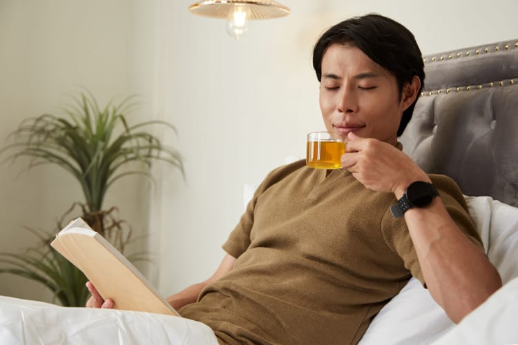 A man drinking some chamomile tea.