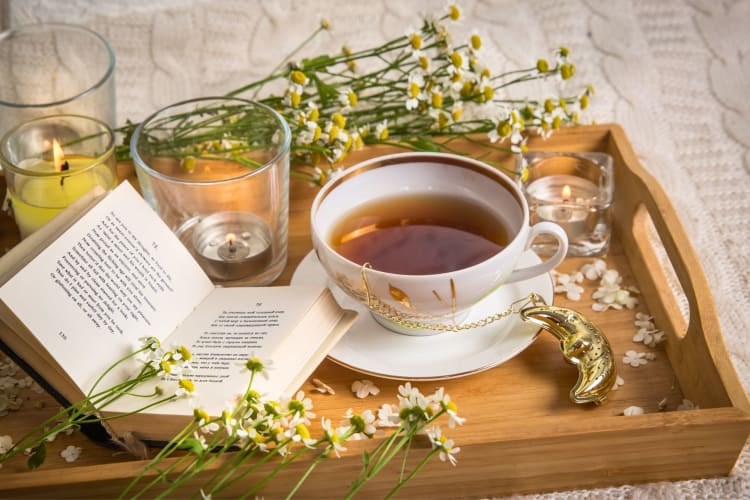 Herbal chamomile tea on a tray.
