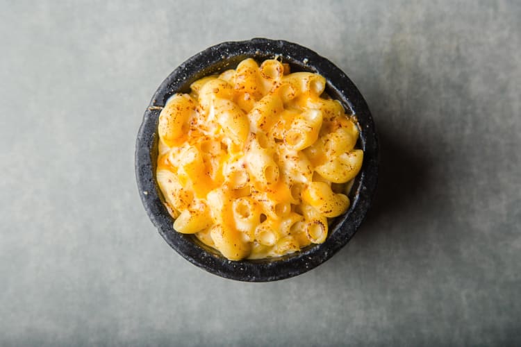 Mac and cheese in a small black bowl
