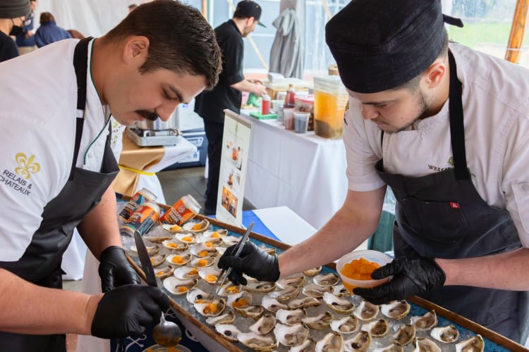 Two chefs serving oysters