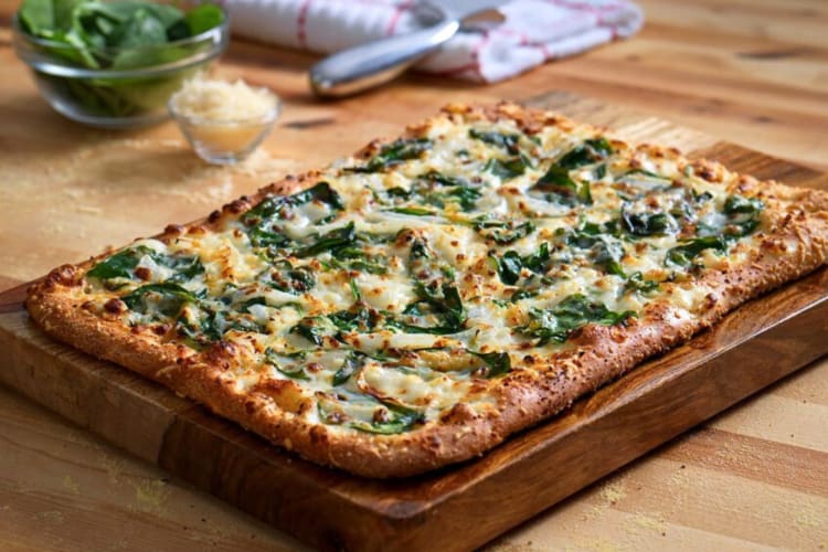 The Spinach and Feta on a wooden board — one of the best Domino's pizzas for vegetarians