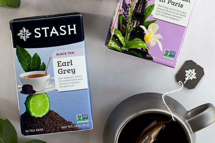 A box of Stash Tea Earl Grey Tea next to another box and a mug