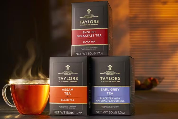 Three boxes of Taylors of Harrogate tea next to a mug with tea in it