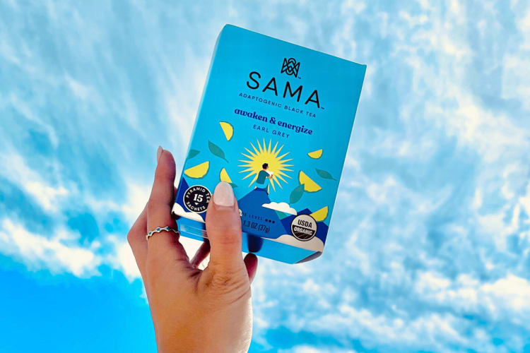 A hand holding a box of Earl Grey Sama Tea, one of the best Earl Grey teas 