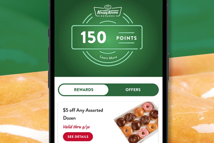 A phone showing a display of a page from the Krispy Kreme app