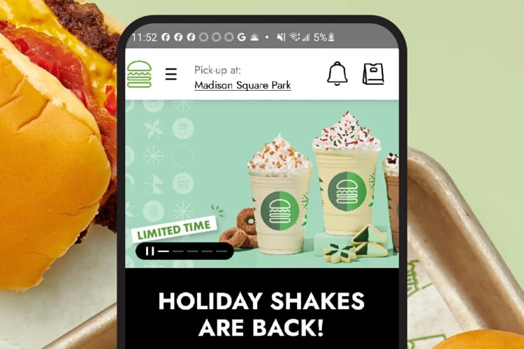 A phone displaying a page from the Shake Shack app