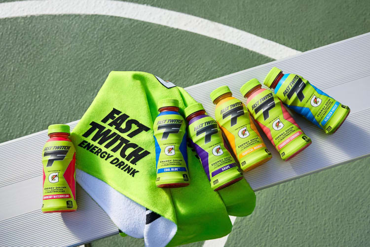 Six Gatorade Fast Twitch bottles and a towel on a bench