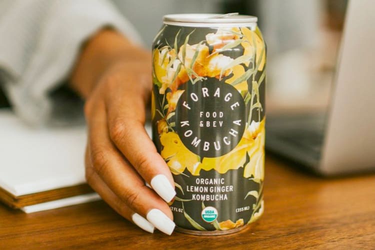 A can of kombucha with a sunflower design