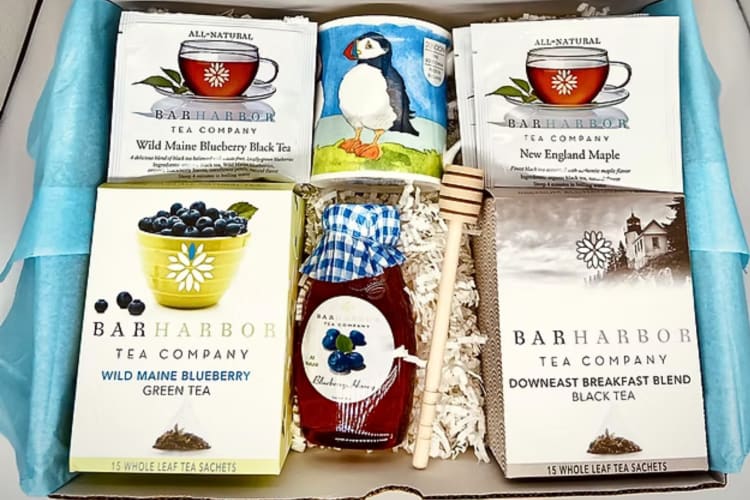 Four Bar Harbour Tea Company teas with a bottle of honey and a mug