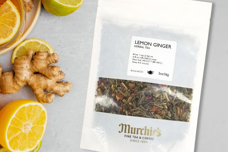 A packet of Murchie's loose-leaf tea next to lemon slices and ginger