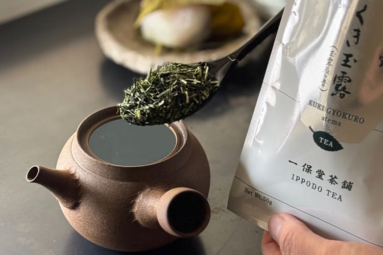 Ippodo Tea leaves, one of the best loose-leaf teas, on a spoon above a teapot