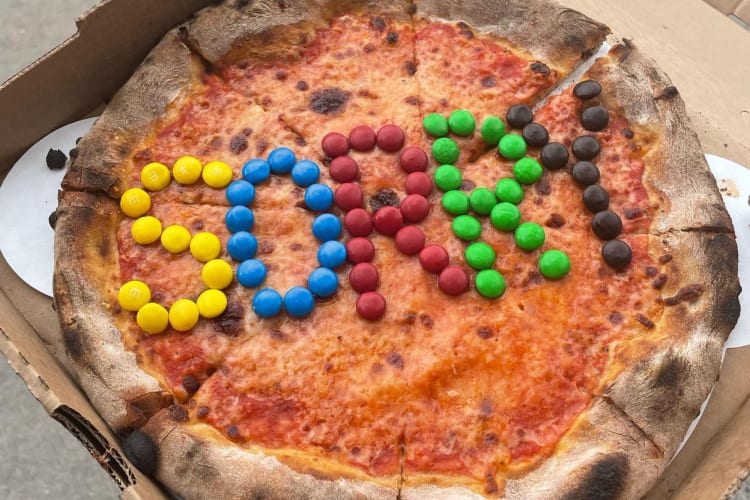 A cheese pizza with SORRY spelled out in candy.