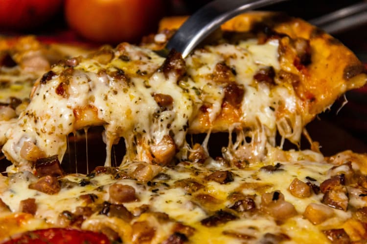 Cheese, meat and onion pizza slice.