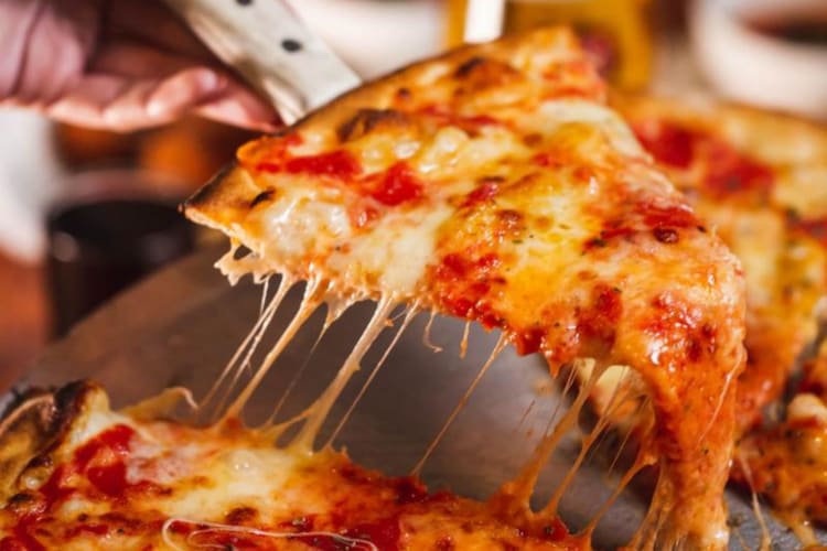 A cheesy slice of the best pizza in NYC.