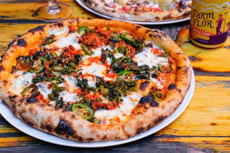 pizza with Italian sausage, broccoli rabe, burrata, jalapeños and Calabrian chili