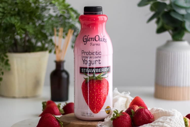 A bottle of GlenOaks Strawberry Drinkable Yogurt with strawberries