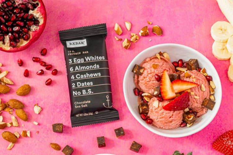 A protein bar with strawberry ice cream next to it.