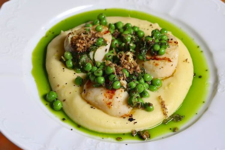 Scallops with mashed potato, peas, truffle and basil oil