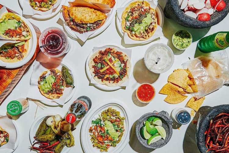 Aerial view of a variety of meals and drinks from Los Tacos No.1