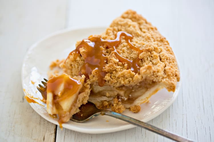 Slice of appple pie drizzled with caramel sauce