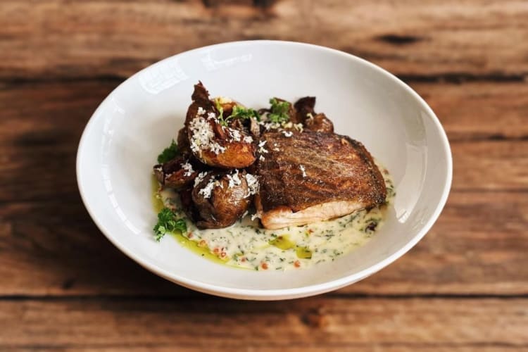 Salmon served with crispy confit potato, lemon and horseradish