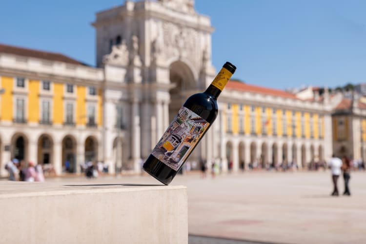 A bottle of Porta 6 Tinto, one of the bets Trader Joe's wines, with a building in the background