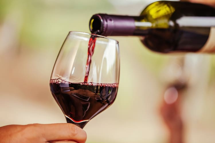 Red wine being poured from a bottle into a glass