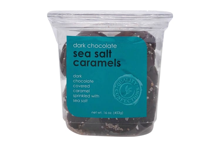 A tub of Quality Confections Dark Chocolate Sea Salt Caramels, one of the best Whole Foods products