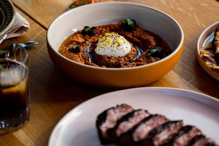 Smoked eggplant spread served alongside a wagyu picanha steak