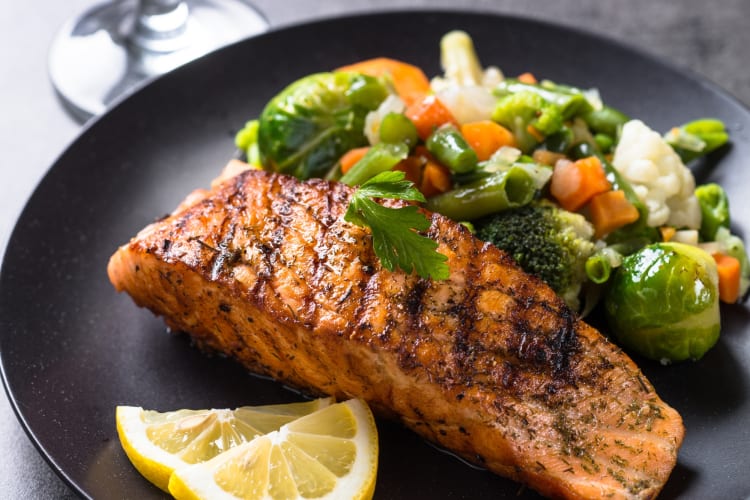 Grilled salmon fillet with vegetables on a plate