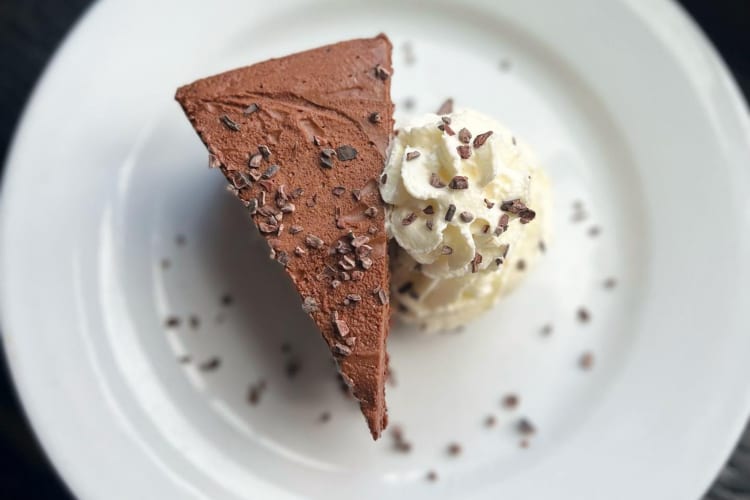 Flourless chocolate torte with whipped cream.