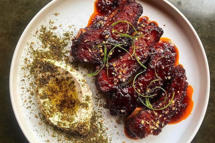 Baby back pork ribs, harissa honey, za’atar and labneh 