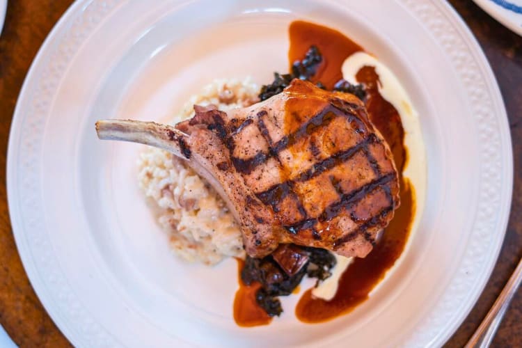 Pork chop served with prosciutto risotto