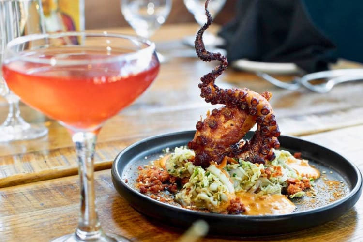 Crispy Octopus served with charred corn esquites and paired with a cocktail